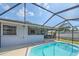 Backyard view of refreshing pool and screened lanai seating area at 108 Stanford Rd, Venice, FL 34293