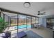 Enclosed patio with a cozy seating area, dining set, and refreshing pool view at 108 Stanford Rd, Venice, FL 34293
