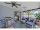 Relaxing screened patio with outdoor seating, grill, fan and stylish decor at 108 Stanford Rd, Venice, FL 34293