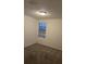 An empty bedroom with neutral paint and carpet features a window with white blinds at 1118 Wynnmere Walk Ave, Ruskin, FL 33570
