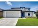 Charming two-story home featuring a well-manicured lawn and a spacious two-car garage with ample driveway space at 1118 Wynnmere Walk Ave, Ruskin, FL 33570