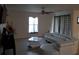 An open living area with tile floors and a unique white couch with patterned curtains at 1118 Wynnmere Walk Ave, Ruskin, FL 33570