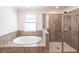 Bathroom featuring tiled garden tub and shower at 11510 Sweetgrass Dr, Bradenton, FL 34212