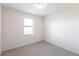 Bright bedroom features a window, neutral paint, and soft carpeting at 11510 Sweetgrass Dr, Bradenton, FL 34212