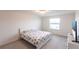 Clean bedroom featuring neutral colors, plush carpet and a large window at 11510 Sweetgrass Dr, Bradenton, FL 34212