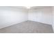 Spacious bedroom with neutral walls, carpet, and a double-door closet at 11510 Sweetgrass Dr, Bradenton, FL 34212
