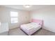 Cozy bedroom features a pink bedframe, plush carpeting, and a window for natural light at 11510 Sweetgrass Dr, Bradenton, FL 34212