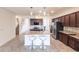 Spacious kitchen with a large island, granite countertops, stainless steel appliances, and dark wood cabinetry at 11510 Sweetgrass Dr, Bradenton, FL 34212