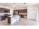 Modern kitchen features a central island, granite countertops, and ample cabinetry for storage at 11510 Sweetgrass Dr, Bradenton, FL 34212