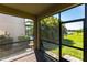 Enclosed brick lanai provides serene views of lush tropical plants and lake at 11510 Sweetgrass Dr, Bradenton, FL 34212