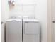 Functional laundry room features a washer, dryer, and wire shelving for storage at 11510 Sweetgrass Dr, Bradenton, FL 34212