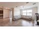 Spacious living room featuring a comfortable sectional sofa, tile floors, and bright windows at 11510 Sweetgrass Dr, Bradenton, FL 34212
