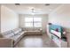 Inviting living room featuring tile floors, a sectional sofa, and a bright window with a view at 11510 Sweetgrass Dr, Bradenton, FL 34212