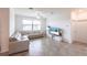 Bright living room with neutral color palette, large windows, tile flooring, and comfortable sectional sofa at 11510 Sweetgrass Dr, Bradenton, FL 34212