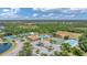 Community aerial view showcasing the pool, clubhouse, sports courts, and verdant landscaping at 11702 Anhinga Avenue, Venice, FL 34292