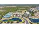 Aerial view of the community amenities including the pool, tennis courts, and clubhouse at 11702 Anhinga Avenue, Venice, FL 34292