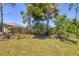 Landscaped backyard with privacy hedges and mature trees at 11702 Anhinga Avenue, Venice, FL 34292