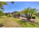 Lush backyard featuring a screened lanai, tropical plants, and well-maintained green lawn at 11702 Anhinga Avenue, Venice, FL 34292