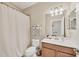 This bathroom features a vanity with great lighting, a mirror, and a shower at 11702 Anhinga Avenue, Venice, FL 34292