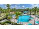 Resort-style community pool featuring palm trees, lounge chairs, umbrellas, and a tiki hut at 11702 Anhinga Avenue, Venice, FL 34292