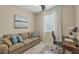 Cozy home office with a sofa, desk, and natural light, perfect for working or relaxing at 11702 Anhinga Avenue, Venice, FL 34292