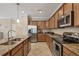 Beautiful kitchen boasts granite counters, stainless steel appliances, and ample cabinet space at 11702 Anhinga Avenue, Venice, FL 34292