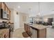 Modern kitchen featuring granite countertops, stainless steel appliances, and an open view to the living room at 11702 Anhinga Avenue, Venice, FL 34292