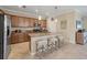 Well-equipped kitchen featuring granite countertops, stainless steel appliances, and an island with seating at 11702 Anhinga Avenue, Venice, FL 34292
