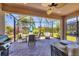 The screened lanai offers an outdoor dining and relaxation space with beautiful views at 11702 Anhinga Avenue, Venice, FL 34292