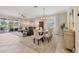 Open concept living area with a dining table and sliding glass doors to the outdoor living space at 11702 Anhinga Avenue, Venice, FL 34292