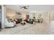 Spacious living room featuring neutral tones, tile floors, and views into the dining area at 11702 Anhinga Avenue, Venice, FL 34292