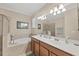 The main bathroom boasts a soaking tub, walk-in shower, and double sink vanity at 11702 Anhinga Avenue, Venice, FL 34292