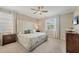 Serene bedroom features an upholstered headboard, soft lighting, and a calm, inviting atmosphere at 11702 Anhinga Avenue, Venice, FL 34292