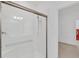Walk-in shower in the bathroom features subway tile and a glass door, enhancing the space's modern appeal at 14265 17Th E Ct, Parrish, FL 34219
