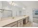 Bathroom with double sinks, a large vanity, and a glass-enclosed shower at 14265 17Th E Ct, Parrish, FL 34219