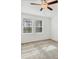 Inviting bedroom featuring neutral carpet, a ceiling fan and bright windows with relaxing nature views at 14265 17Th E Ct, Parrish, FL 34219