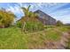 Pool area is surrounded by tropical flowers and plants at 14265 17Th E Ct, Parrish, FL 34219