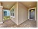Inviting front porch with neutral stucco and a black front door and stylish brick pavers at 14265 17Th E Ct, Parrish, FL 34219