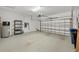 Spacious two-car garage with an automatic door, water heater, and storage shelving at 14265 17Th E Ct, Parrish, FL 34219