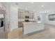 Open kitchen boasts an island, stainless appliances, tile floors and a view into the adjacent living area at 14265 17Th E Ct, Parrish, FL 34219