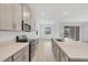 Gourmet kitchen with stainless steel appliances, island, and open view of dining and outdoor entertaining area at 14265 17Th E Ct, Parrish, FL 34219