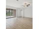 Bright living room featuring tile floors, a ceiling fan, and sliding glass doors to the pool at 14265 17Th E Ct, Parrish, FL 34219
