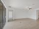 Large living room with tile floors, neutral walls, large sliding glass door and a ceiling fan at 14265 17Th E Ct, Parrish, FL 34219