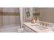 Stylish bathroom with tub, shower, granite countertops, and modern fixtures at 14907 Contenta Loop, Bradenton, FL 34211