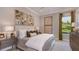 Comfortable bedroom featuring neutral tones, stylish decor, and a view of the golf course at 14907 Contenta Loop, Bradenton, FL 34211