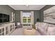 Cozy living room with comfortable seating, a neutral color palette, and a large window overlooking the outdoors at 14907 Contenta Loop, Bradenton, FL 34211