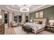 Luxurious main bedroom with decorative wall paneling and large windows filling the room with light at 14907 Contenta Loop, Bradenton, FL 34211