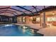 Inviting pool area with spa, covered patio, dining set, and outdoor kitchen, perfect for relaxation and entertainment at 14907 Contenta Loop, Bradenton, FL 34211