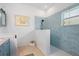 Bathroom featuring a light blue tiled shower, vanity, and tiled floors at 1520 Dorgali Dr, Sarasota, FL 34238