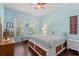 Bedroom with light blue walls, hardwood floors, ceiling fan, and window at 1520 Dorgali Dr, Sarasota, FL 34238